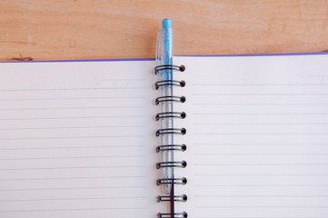 Pen and Notepad on the wooden desk