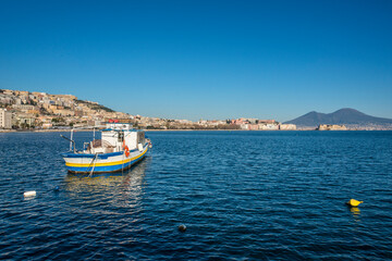 Fototapeta na wymiar Fishermen boat in the Naples bay (Napoli bay), Italy