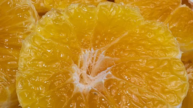 Fresh sweet orange rotating. Extreme macro of juicy tangerine, rich in natural antioxidants. concept of orange fruits, vitamins and natural antioxidants to the skin for beauty. Close up 4k fruit foota