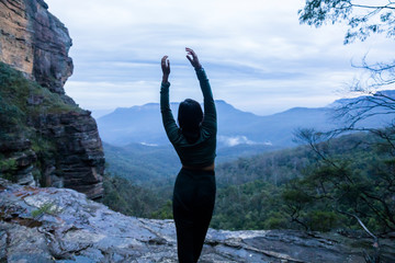 Female doing yoga pose in front of valley at Blue Mountains