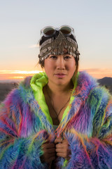 Young asian female dressed in rainbow furry coat for festival