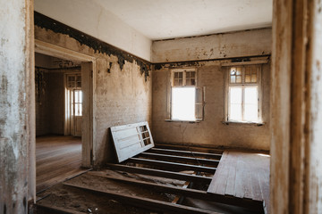 abandoned old house in ruined partially collapsed ghost town