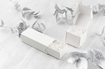 Luxury white blank open two gift boxes - square, rectangle filler mock up on wood board silver branch side view for design, branding identity, advertising.