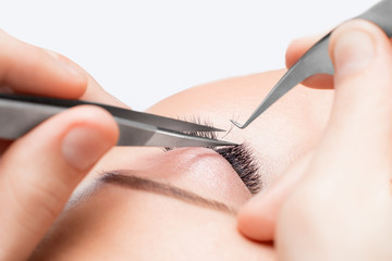 Macro photo woman with long lashes in beauty salon. Concept eyelash extension procedure