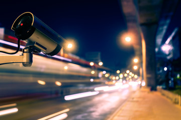 CCTV, Surveillance camera operating in city watching traffic road at night