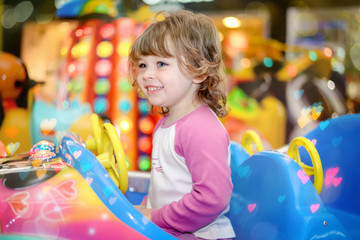 cute little girl in a merry-go-round