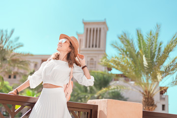 Happy Asian tourist girl walks through the old Arab city in Dubai, United Arab Emirates