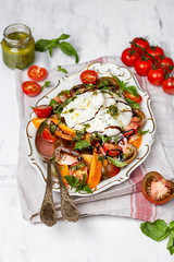 Buffalo burrata cheese with fresh raw tomatoes and basil
