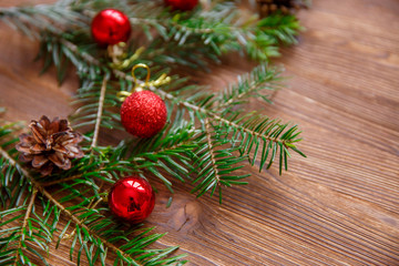 Christmas background with xmas tree and red berries on  wooden background. Merry christmas greeting card, frame, banner. Winter holiday theme. Happy New Year. 