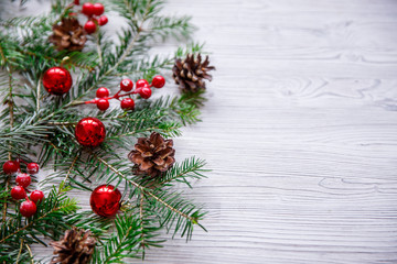Christmas background with xmas tree and red berries on white wooden background. Merry christmas greeting card, frame, banner. Winter holiday theme. Happy New Year. Space for text.