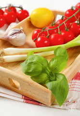 Wooden serving tray wit fresh vegetables and fruit