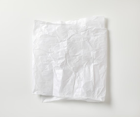 Crumpled white waxed packing paper