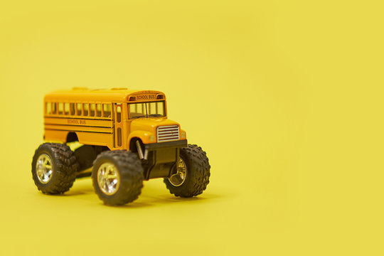 Yellow School Bus on big wheels. Transfer to school To study Safe, Soft focus and blur. And vintage style. Monster truck