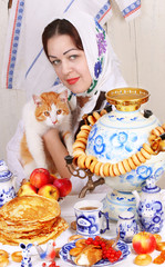 The girl holds a red cat in her arms. Maslenitsa