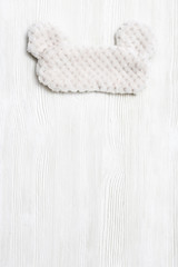 Soft fluffy sleep mask for eye on white background. Top  view.