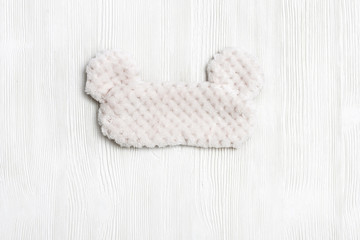 Eye mask for sleeping made of fluffy faux fur on white background. View from above