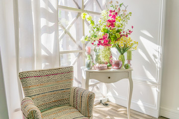 Easter interior decoration. Beatuful composition with candles. eggs, rabbit, apples and blooming flowers.