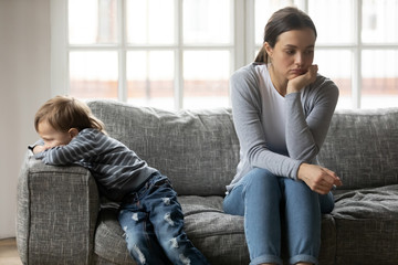 Young mom and little son not talking after misunderstanding