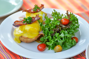 egg benedict or bun with egg and ham topping
