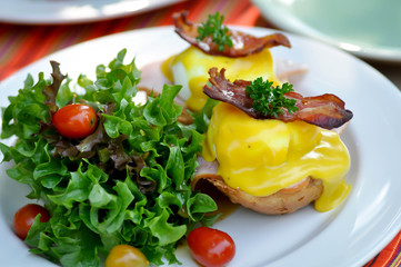 egg benedict or bun with egg , ham and bacon