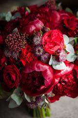 large buds of red roses in an expensive bouquet. close-up of a bouquet of huge red roses on a light background