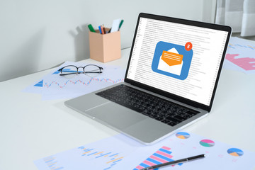 Person using a laptop computer with email communication connection message online and chat on social media with global letters concept. Laptop mockup with clipping path on screen.