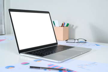 Blank screen laptop computer on wood table with clipping path. business concept. Mockup with copy space.
