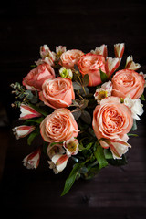 dark luxurious bouquet of gorgeous pink roses for Valentine's day on a dark wood background