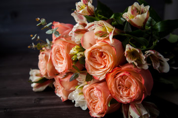 dark luxurious bouquet of gorgeous pink roses for Valentine's day on a dark wood background