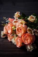 dark luxurious bouquet of gorgeous pink roses for Valentine's day on a dark wood background