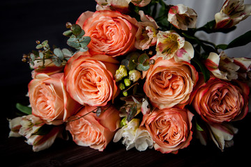 dark luxurious bouquet of gorgeous pink roses for Valentine's day on a dark wood background