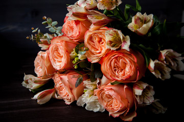 dark luxurious bouquet of gorgeous pink roses for Valentine's day on a dark wood background