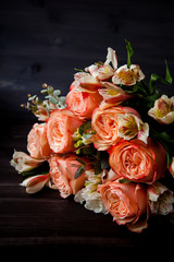 dark luxurious bouquet of gorgeous pink roses for Valentine's day on a dark wood background