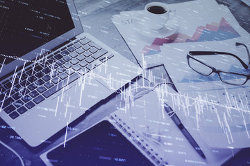 Forex market chart hologram and personal computer background. Double exposure. Concept of...