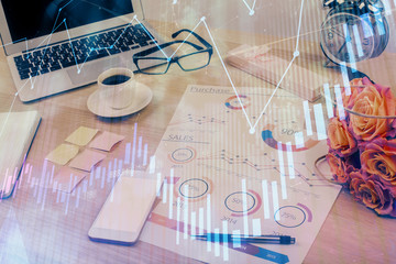 Financial graph colorful drawing and table with computer on background. Double exposure. Concept of international markets.