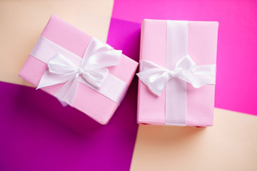 Holiday design template with festive gift boxes wrapped with ribbons. Multicolored background, copy space. Birthday, Valentines, mother's day, celebration concept