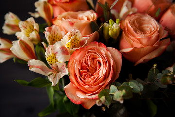 dark luxurious bouquet of gorgeous pink roses for Valentine's day on a dark wood background