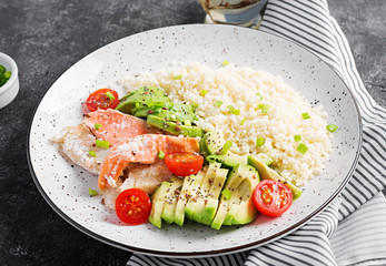 Healthy meal.  Salad with salmon, couscous, avocado and tomatoes.  Eastern oriental lunch