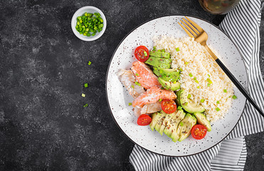 Healthy meal.  Salad with salmon, couscous, avocado and tomatoes. Top view, copy space, overhead....