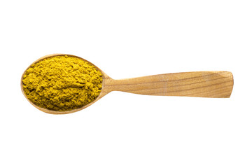 curry powder in wooden spoon isolated on white background. spice for cooking food, top view.