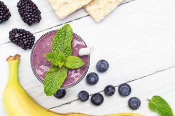 Banana, blueberry, blackberry, oatmeal and yogurt smoothies in a glass