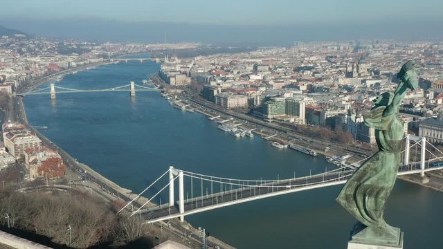 Budapest, Hungary - 4K drone flying by the Statue of Liberty and Citadel on Gellert Hill on a sunny winter day with Elisabeth Bridge