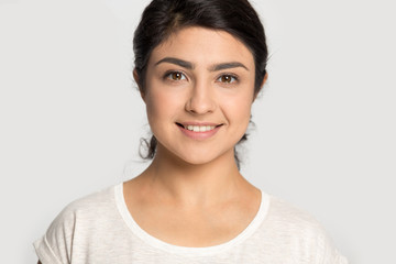 Head shot portrait pleasant attractive happy smiling indian young woman.