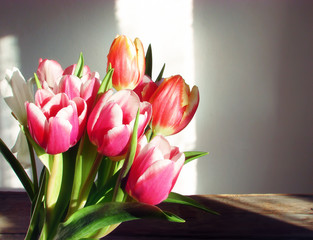 Bouquet of tulips on a background of a wall lit by the sunBouquet of tulips on the background wall illuminated by the sun