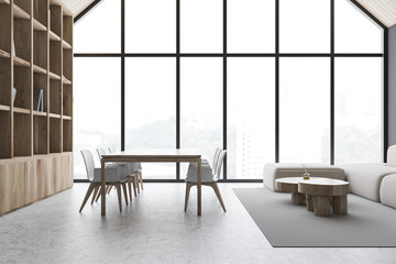 Gray attic dining room with bookcase and sofa
