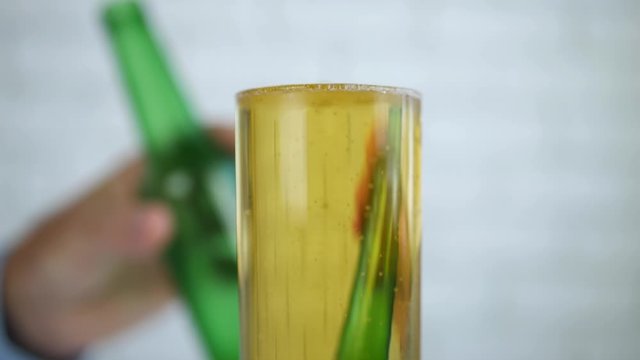 Man with a Glass Full on the Table Drinking Beer from the Glass