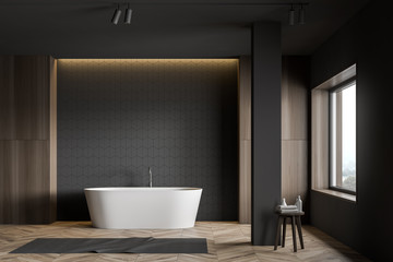 Gray tile and wood bathroom with tub and column