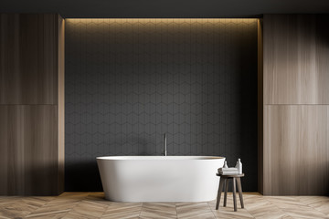 Obraz na płótnie Canvas Gray tile and wood bathroom interior with tub