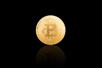 Bitcoin physical gold coin isolated on black