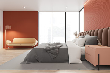 Fototapeta premium Orange master bedroom with sofa